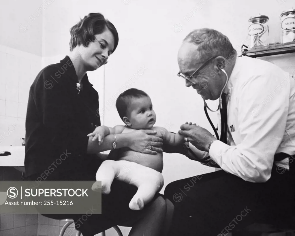 Side profile of a pediatrician examining a baby