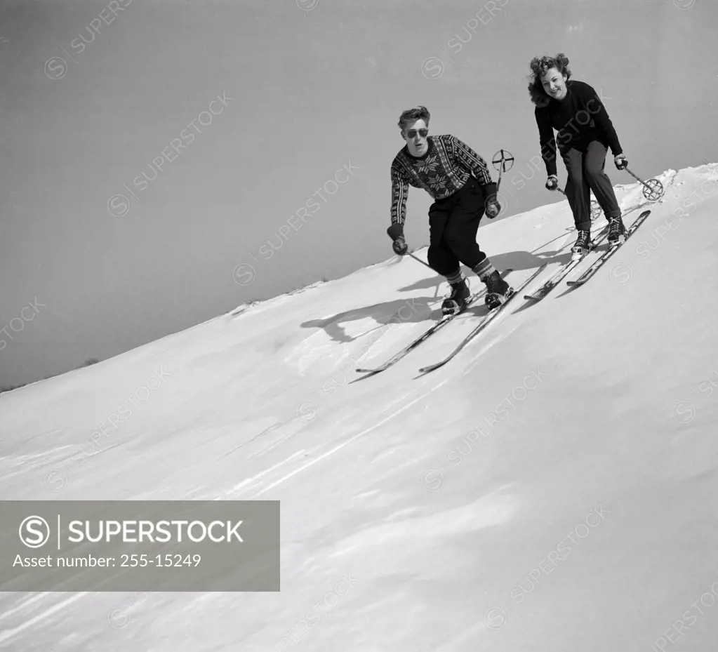 Young couple skiing down the slope