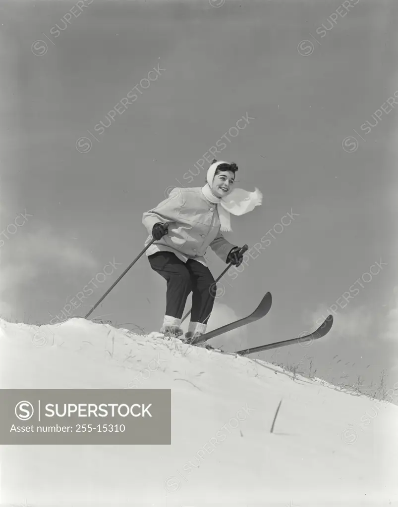 Vintage Photograph. Woman on skis at top of hill.