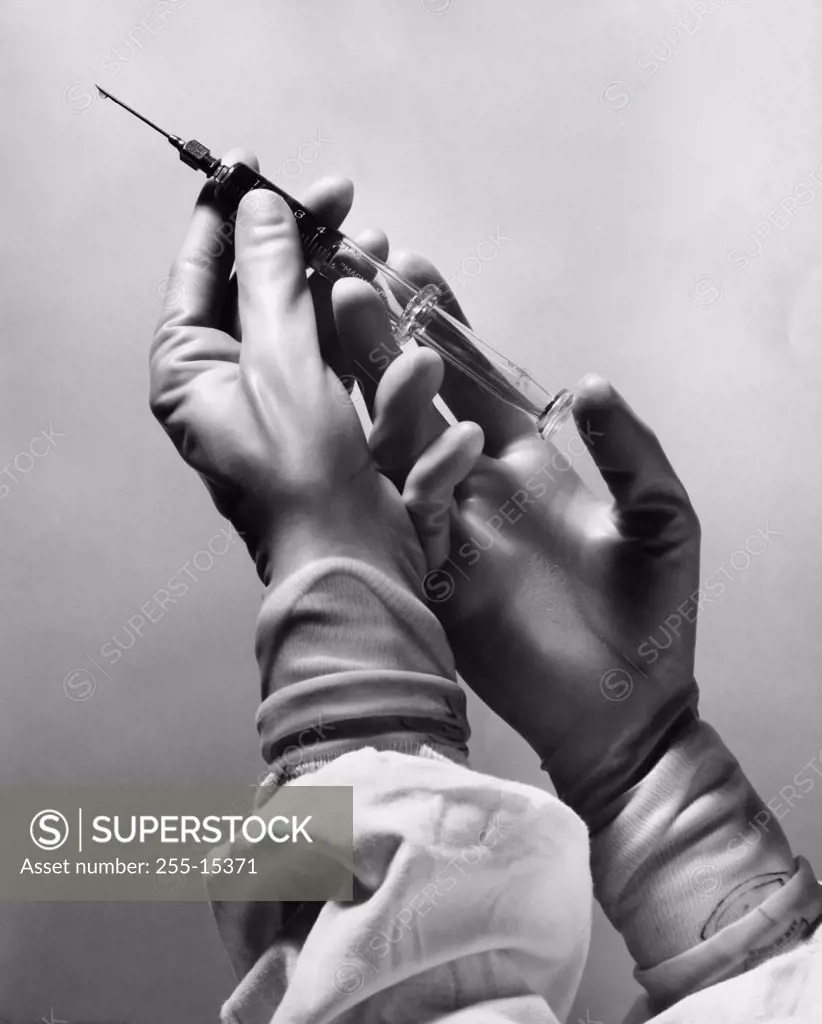 Surgeon's hands holding a syringe