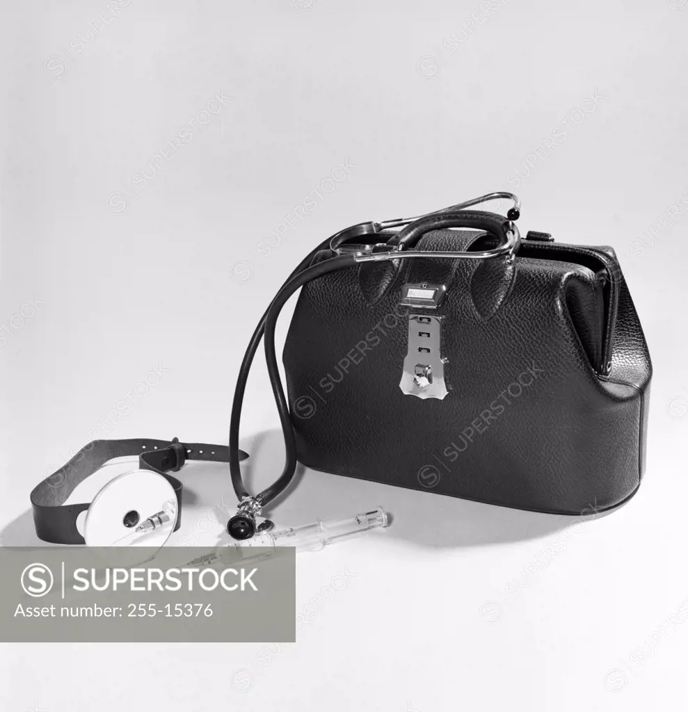 Close-up of medical equipment near doctor's bag, 1950s