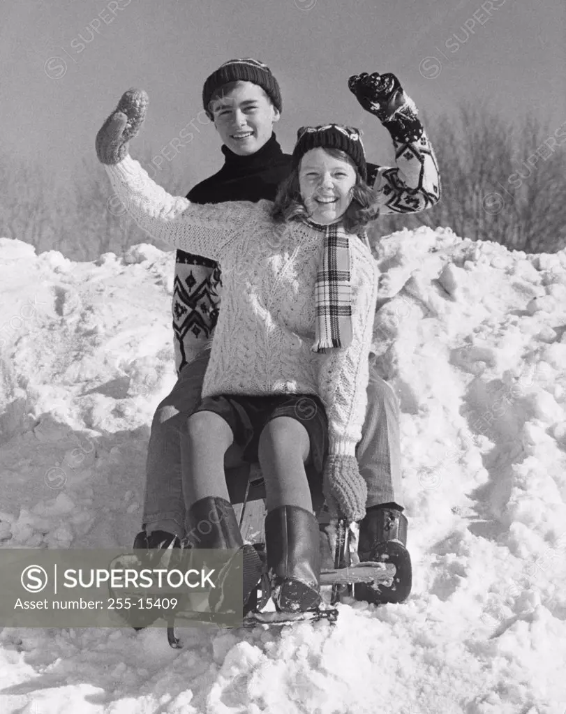 Teenage couple on a sled