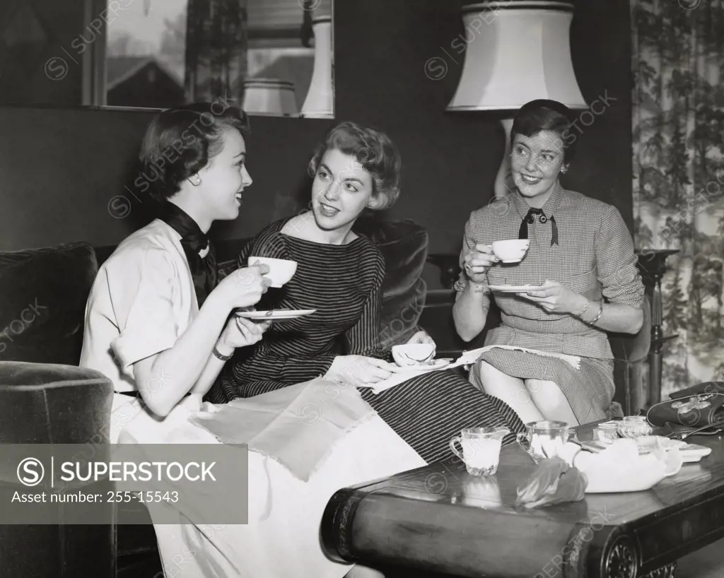 Three young women drinking tea