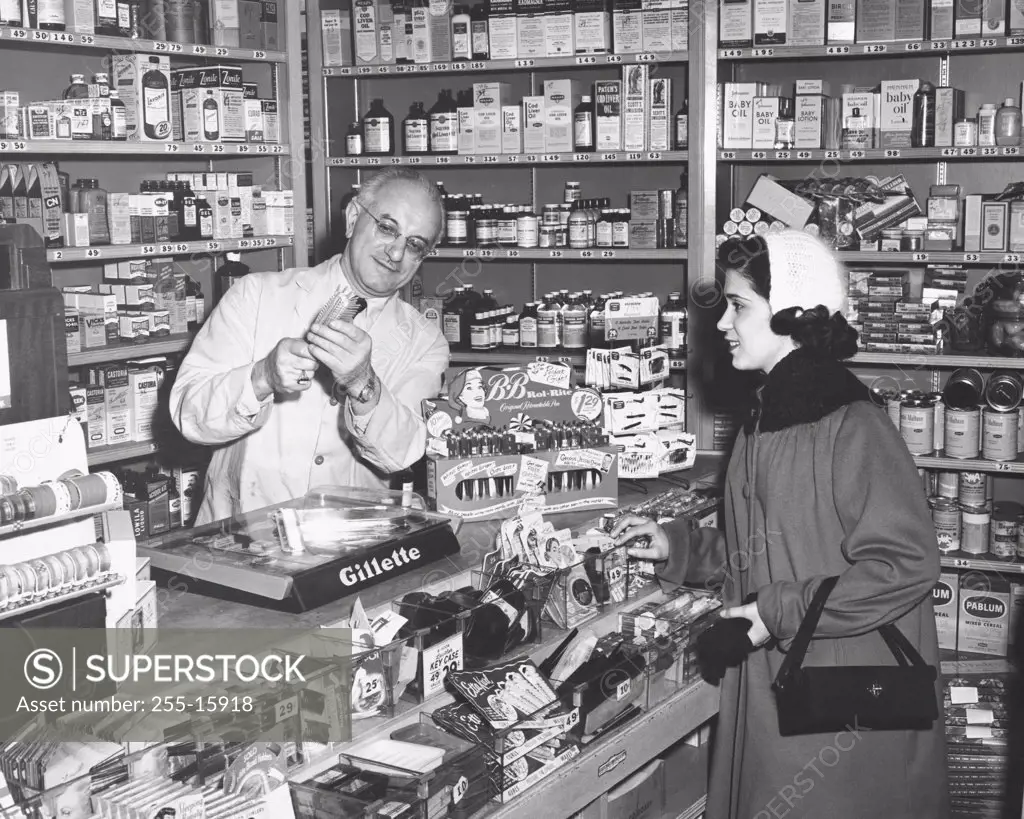 Pharmacist demonstrating a product to a young woman