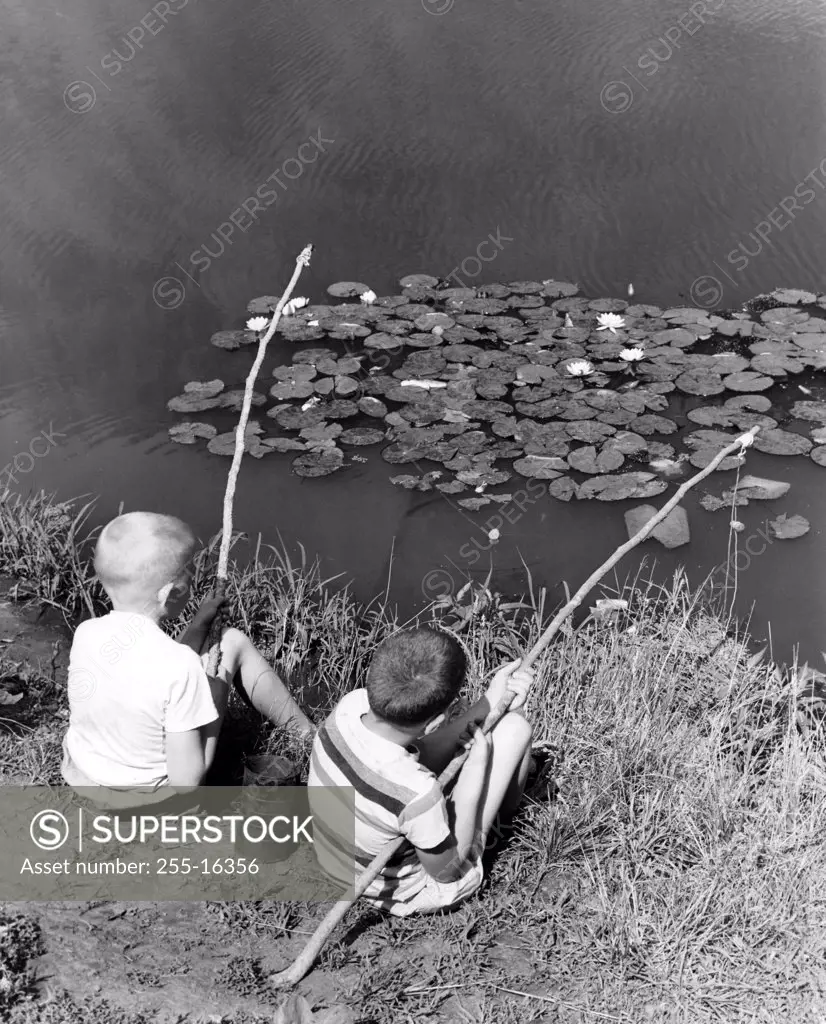 Vintage photograph of boys fishing with improvised fishing rods