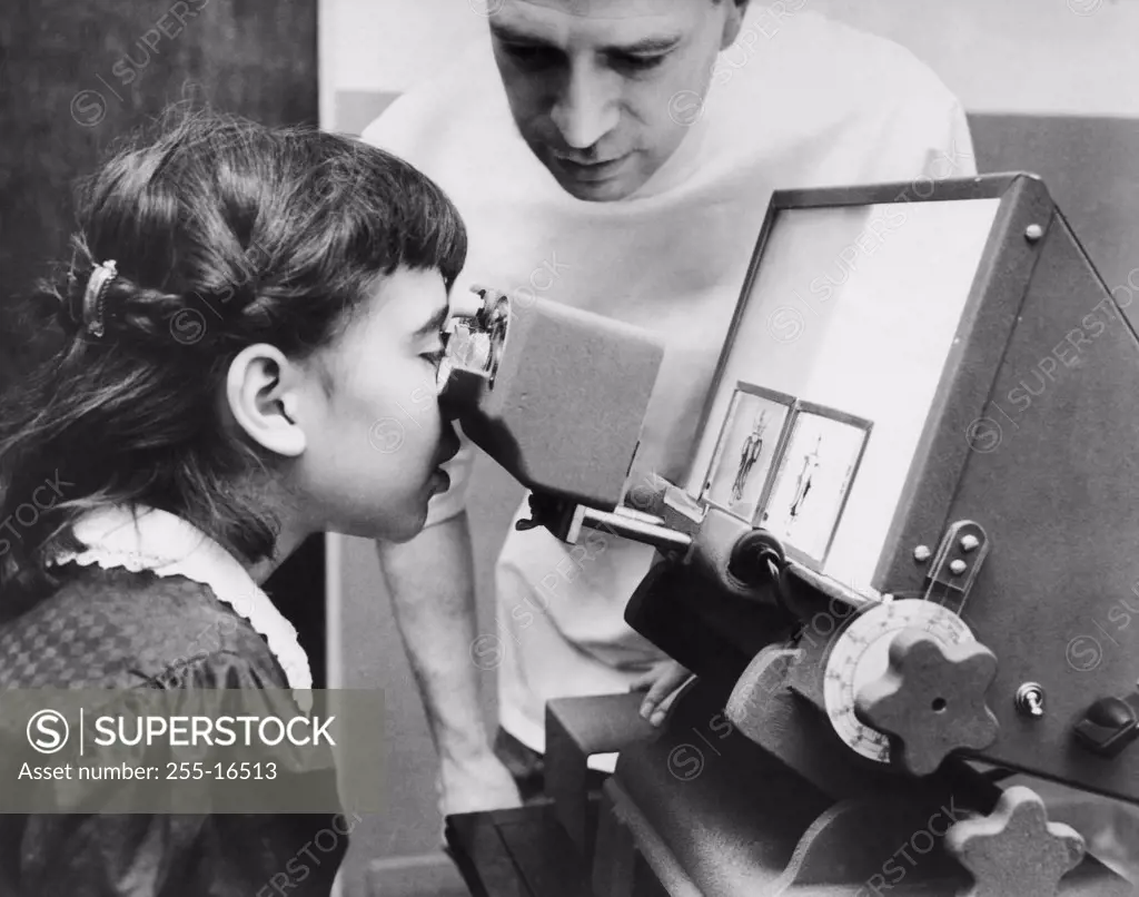 Male optometrist examining the eyes of a patient, 1950