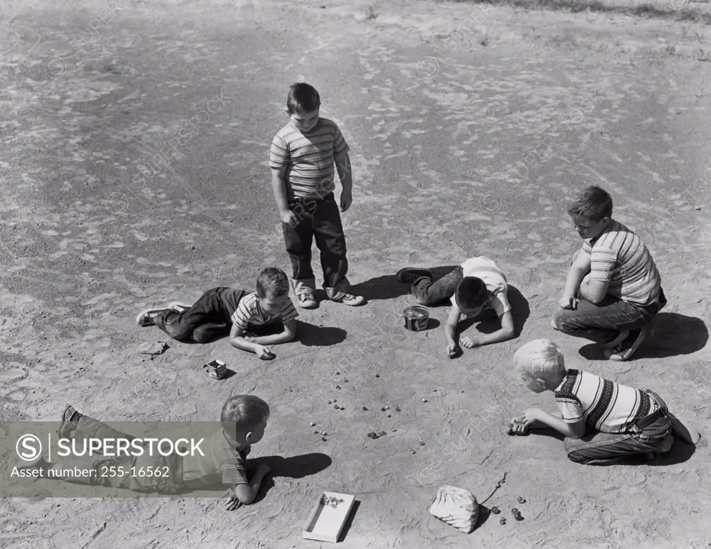 High angle view of a group of boys playing marbles