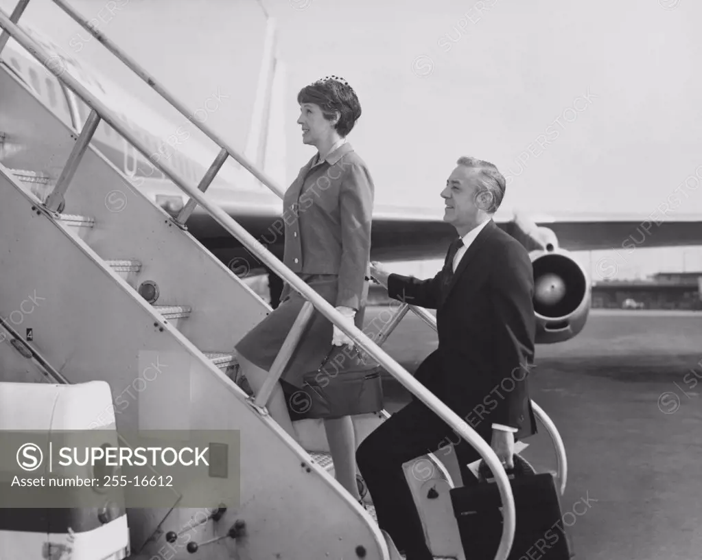 Mature couple boarding an airplane