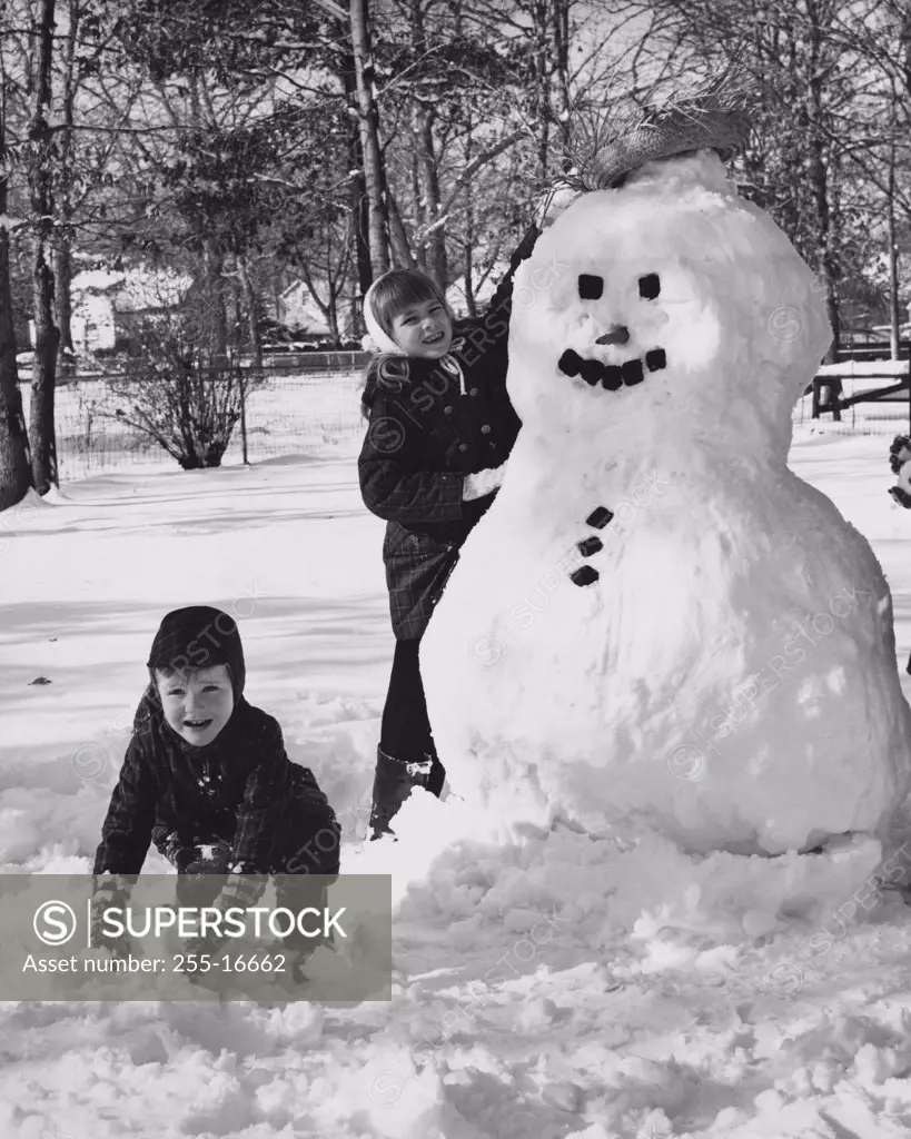 Two girls making a snowman