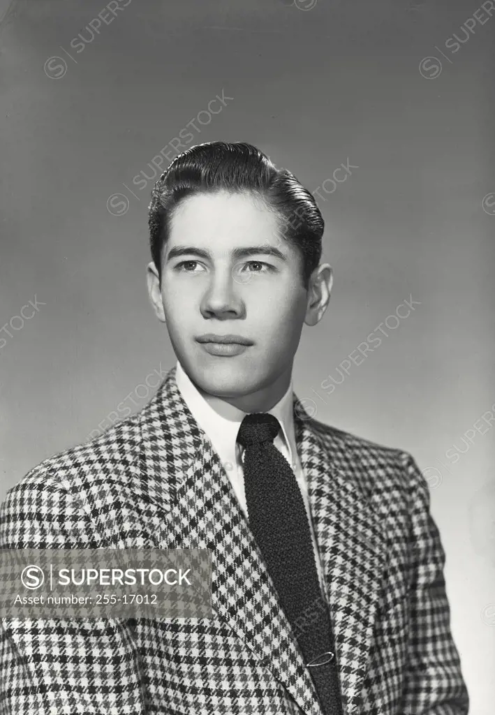 Vintage photograph. Close-up of a teenage boy in jacket and tie