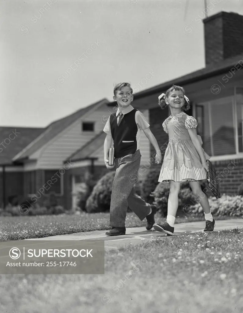 Vintage Photograph. Young boy and girl walking down path together. Frame 8