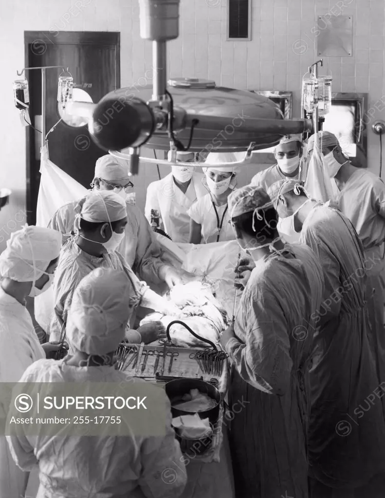 High angle view of surgeons performing a surgery in an operating room