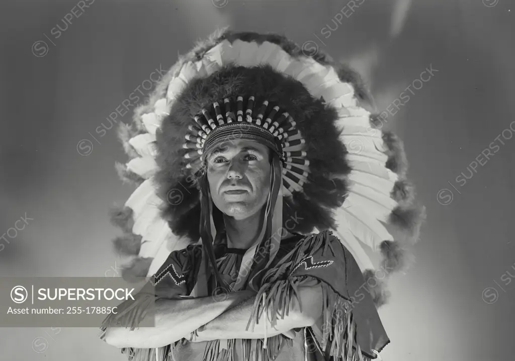 Vintage Photograph. Caucasian man in Native American head dress. Frame 1
