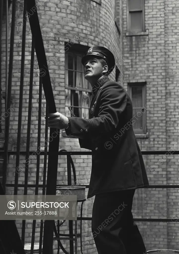 Vintage Photograph. Police officer lurking in fire escape. Frame 1