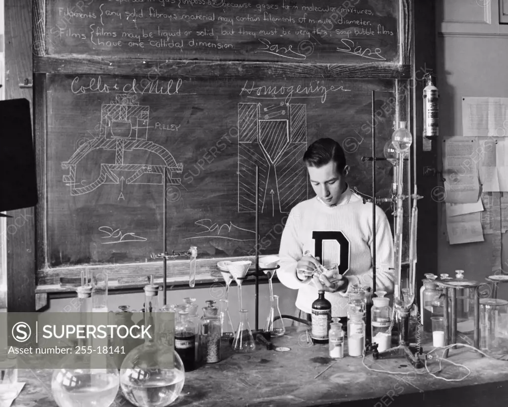 Boy performing an experiment in a chemistry laboratory