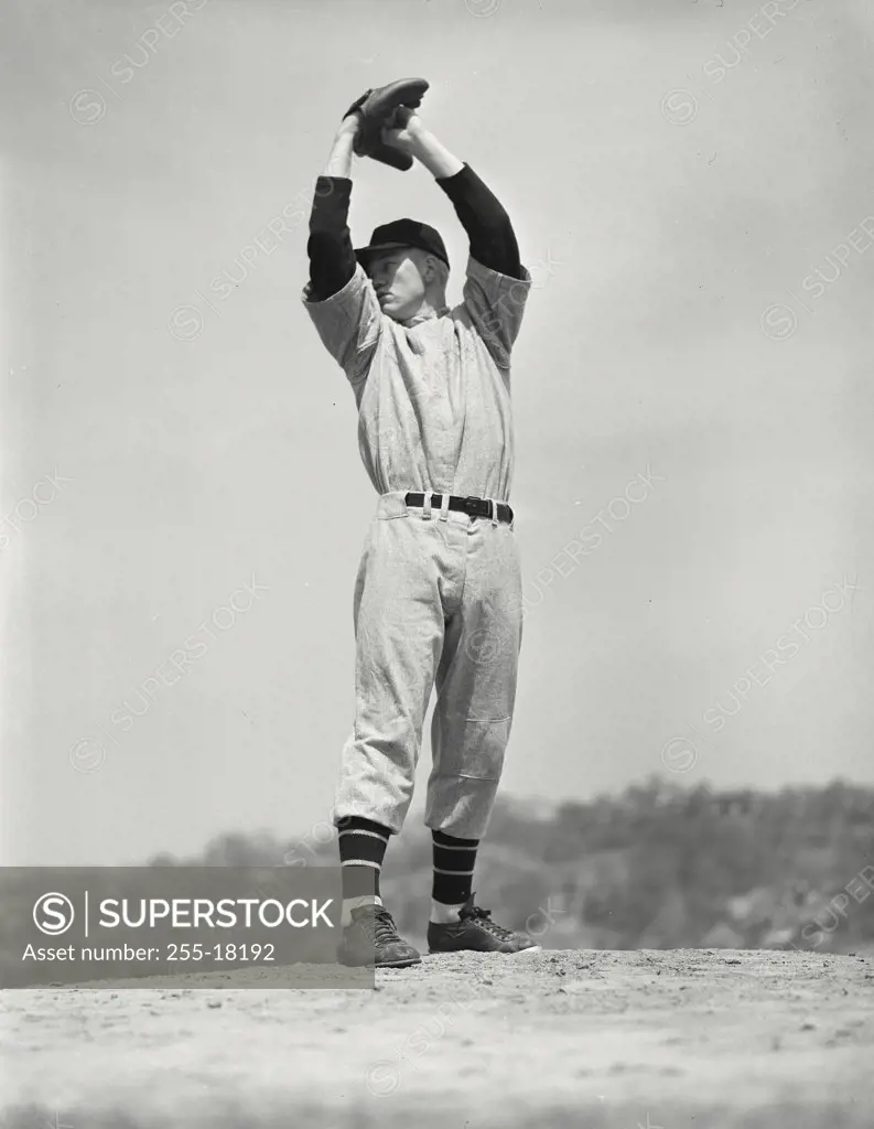 Baseball pitcher with arms raised up before pitch