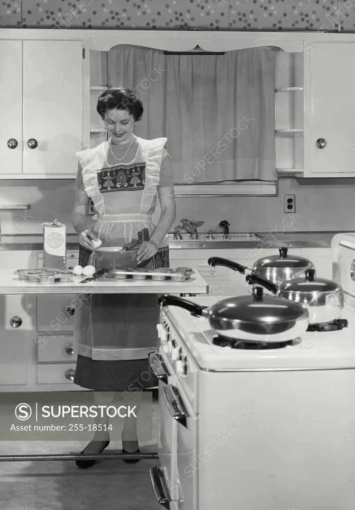 Vintage Photograph. Young matron seen preparing dinner. Frame 6