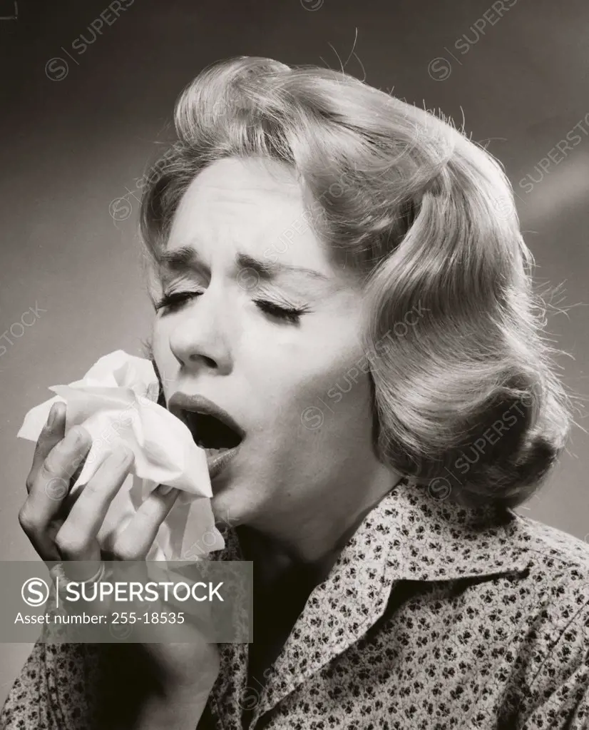 Close-up of a young woman sneezing