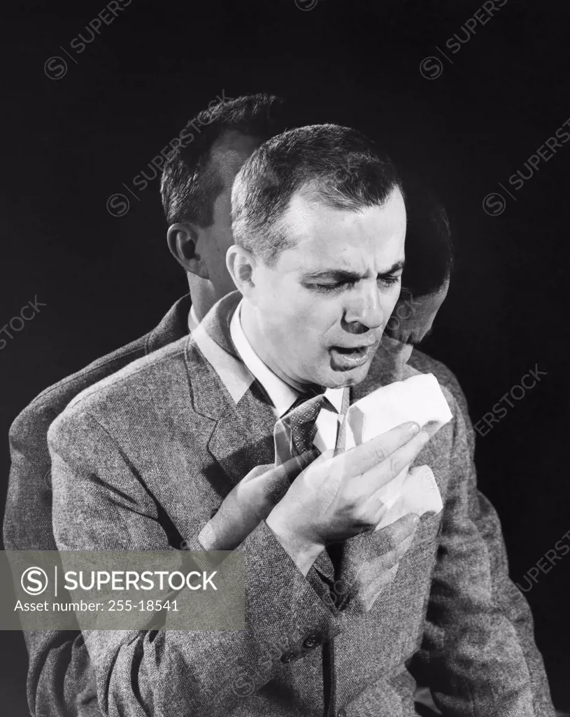 Close-up of a mature man sneezing