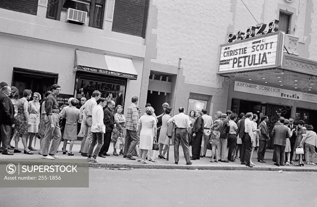 Group of people standing in front of a movie theater