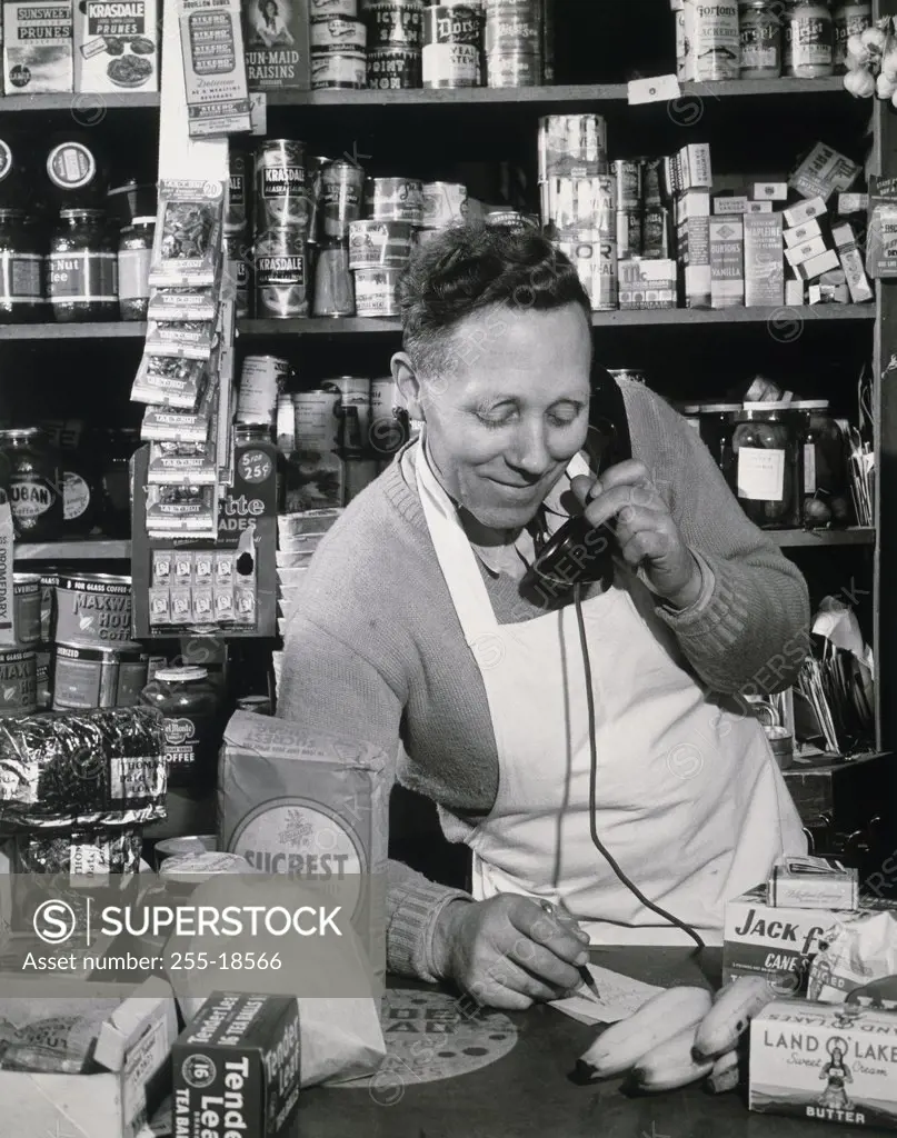 Grocer taking order on telephone