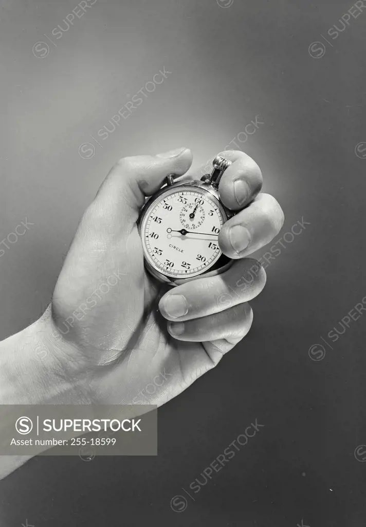 Vintage photograph. Closeup of hand holding stopwatch