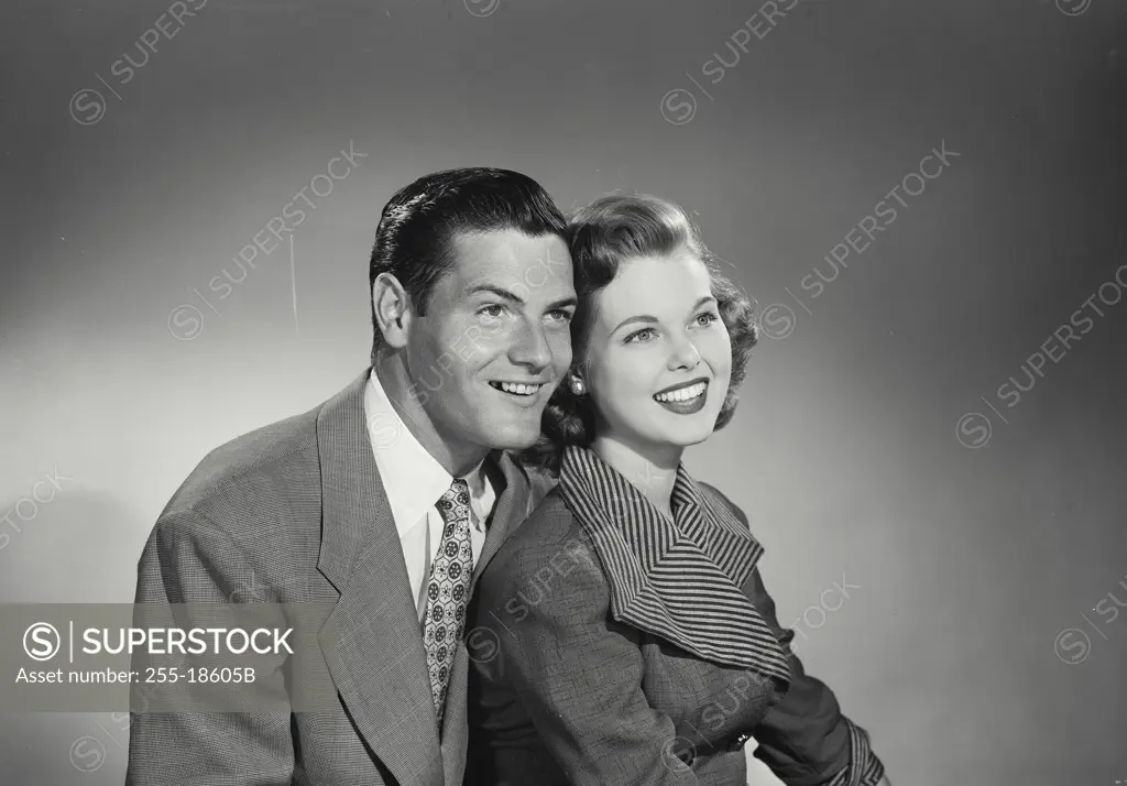 Vintage Photograph. Man and woman sitting together and smiling off camera