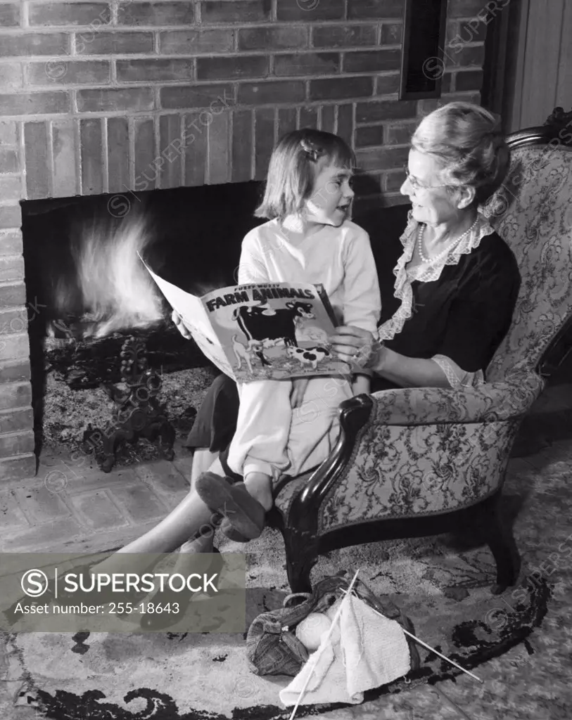 Grandmother reading a story to her granddaughter