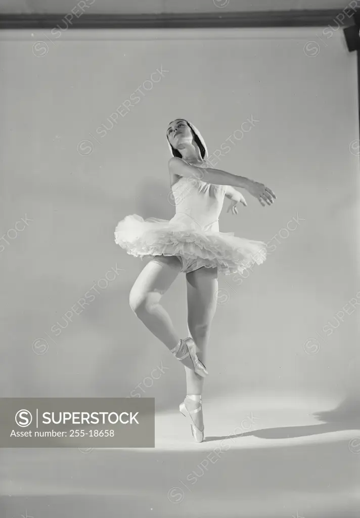 Vintage photograph. Ballet dancer on white backround.