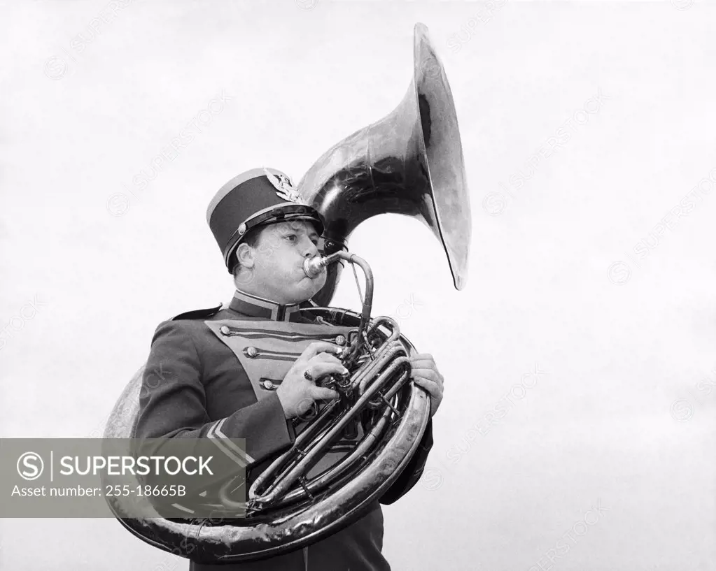 Studio shot of man playing tuba