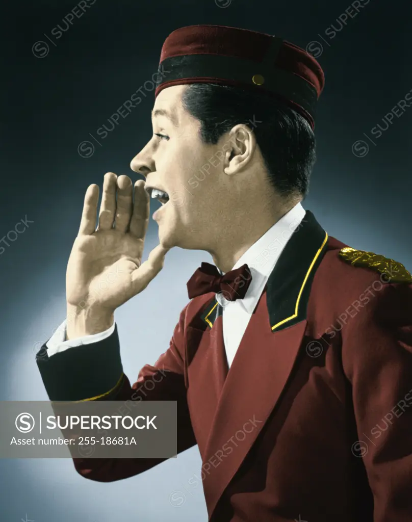 Colorized Vintage Photograph. Bellman raising hand to call out while turned to side