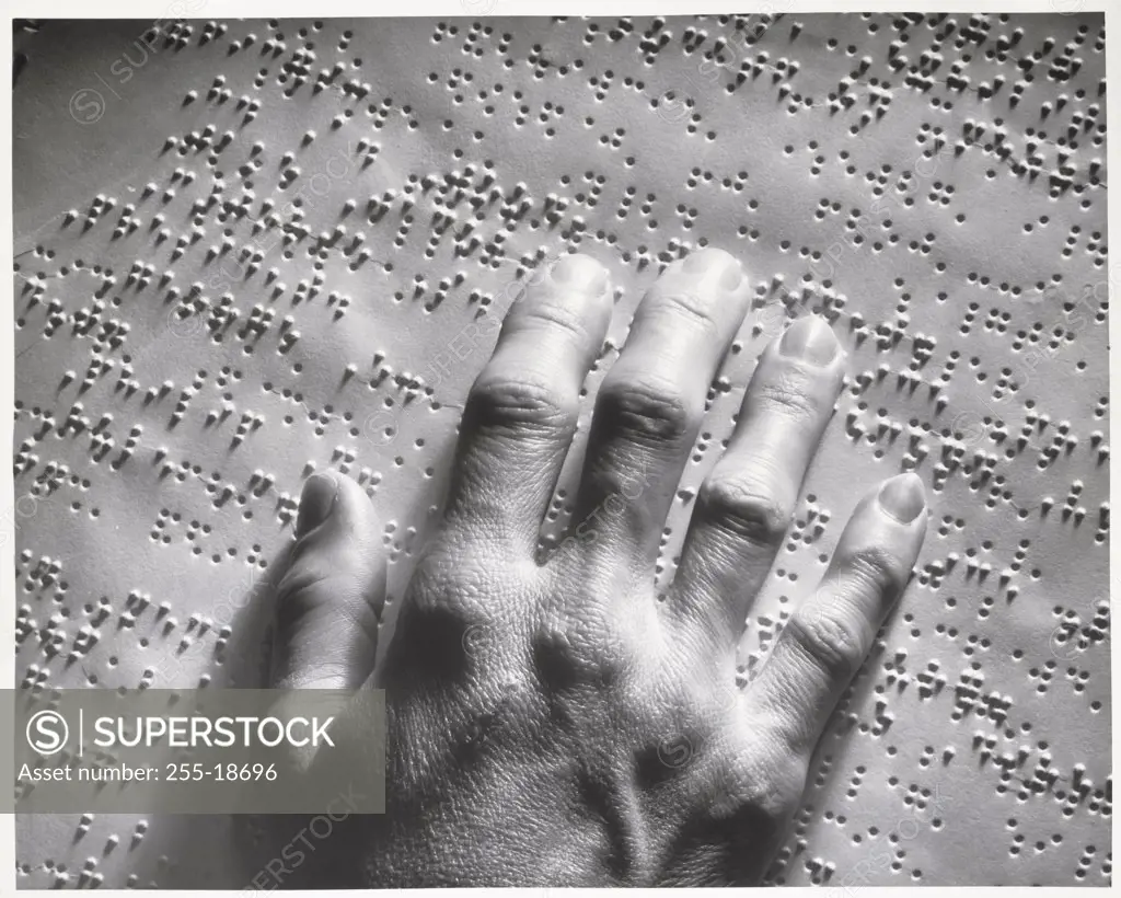 Close-up of a blind person reading Braille script