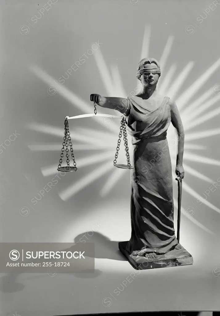 Vintage Photograph. Statue depicting Lady Justice holding the scales of Justice and sword with light ray pattern on background, Frame 2