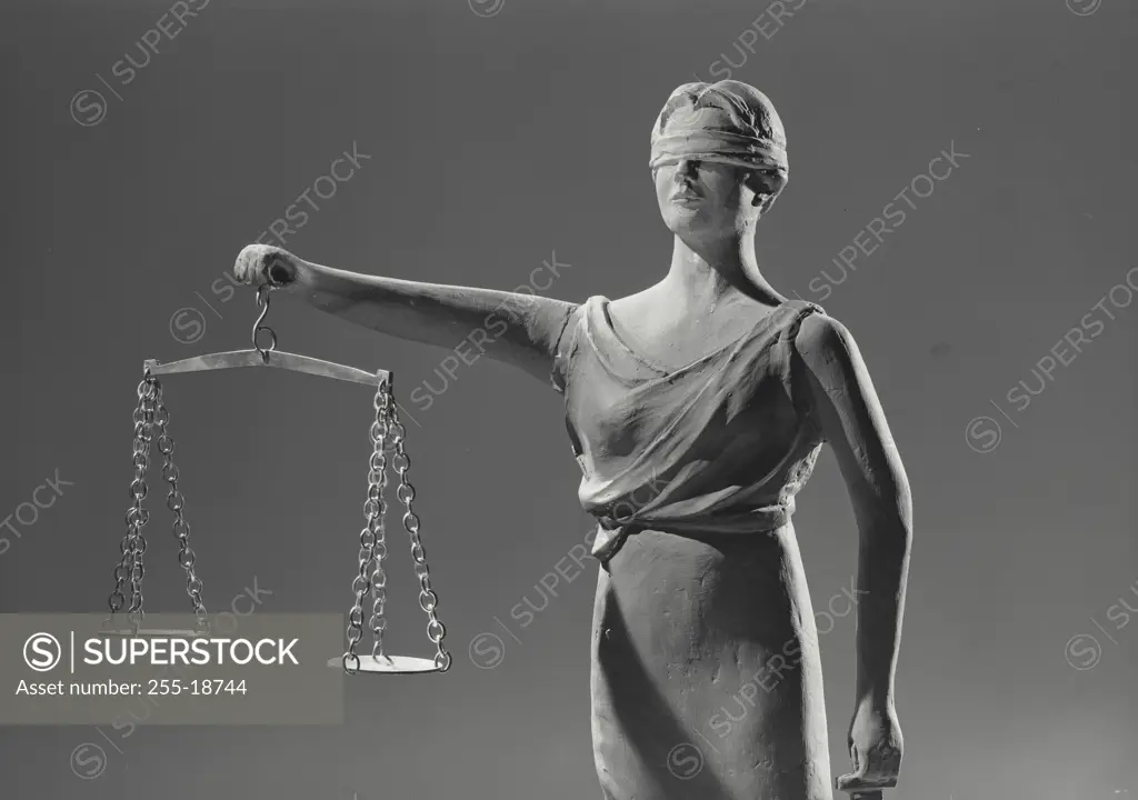 Vintage Photograph. Closeup of Statue depicting Lady Justice holding the scales of Justice and sword, Frame 1