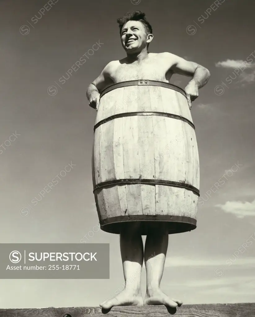 Low angle view of a young man wearing a barrel