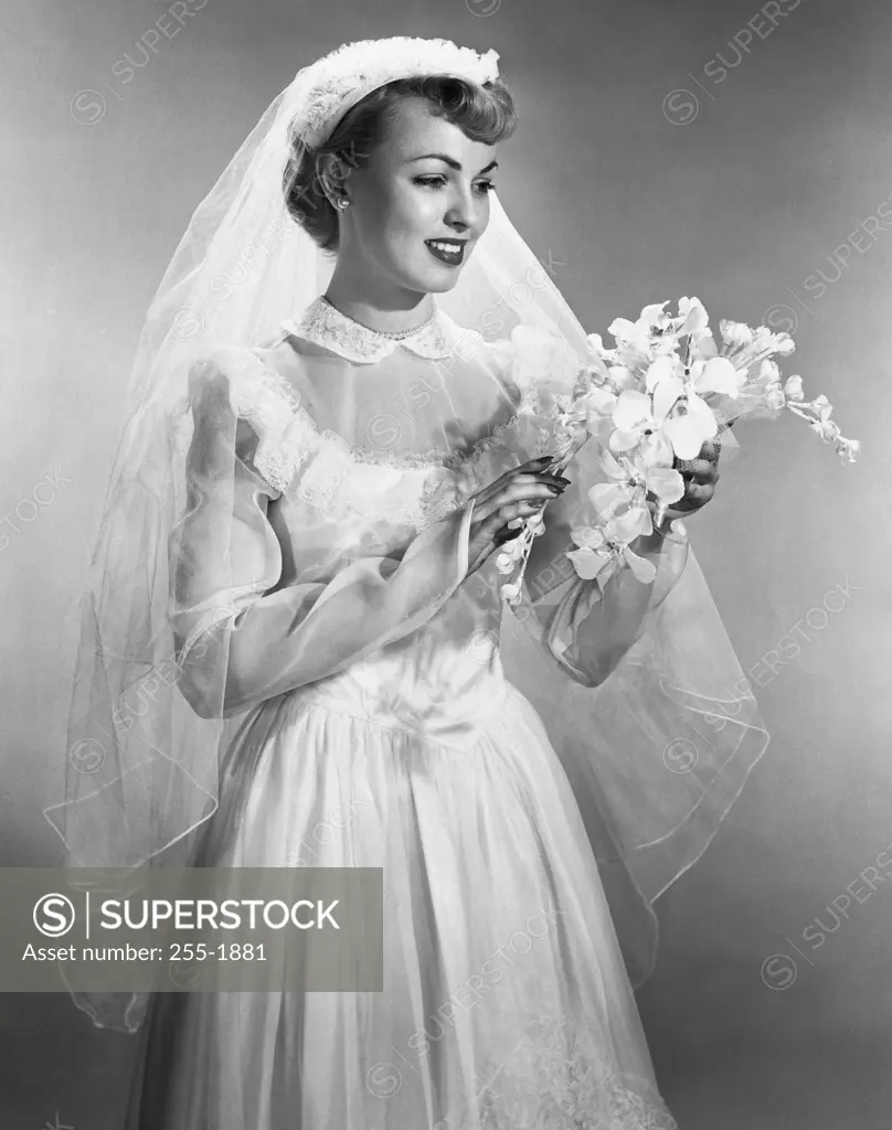 Bride smiling and holding a bouquet