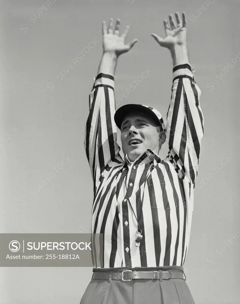 Vintage photograph. Football referee showing touchdown signal