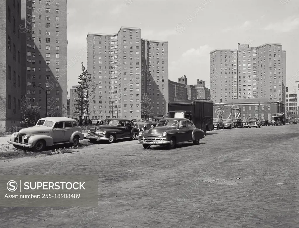 Vintage photograph. Cars drive by units of the Alfred E Smith Housing Project on the Lower East Side