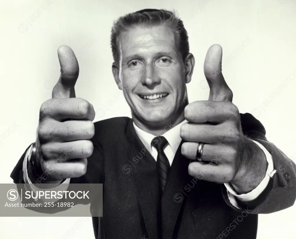 Portrait of a business showing a thumbs up sign