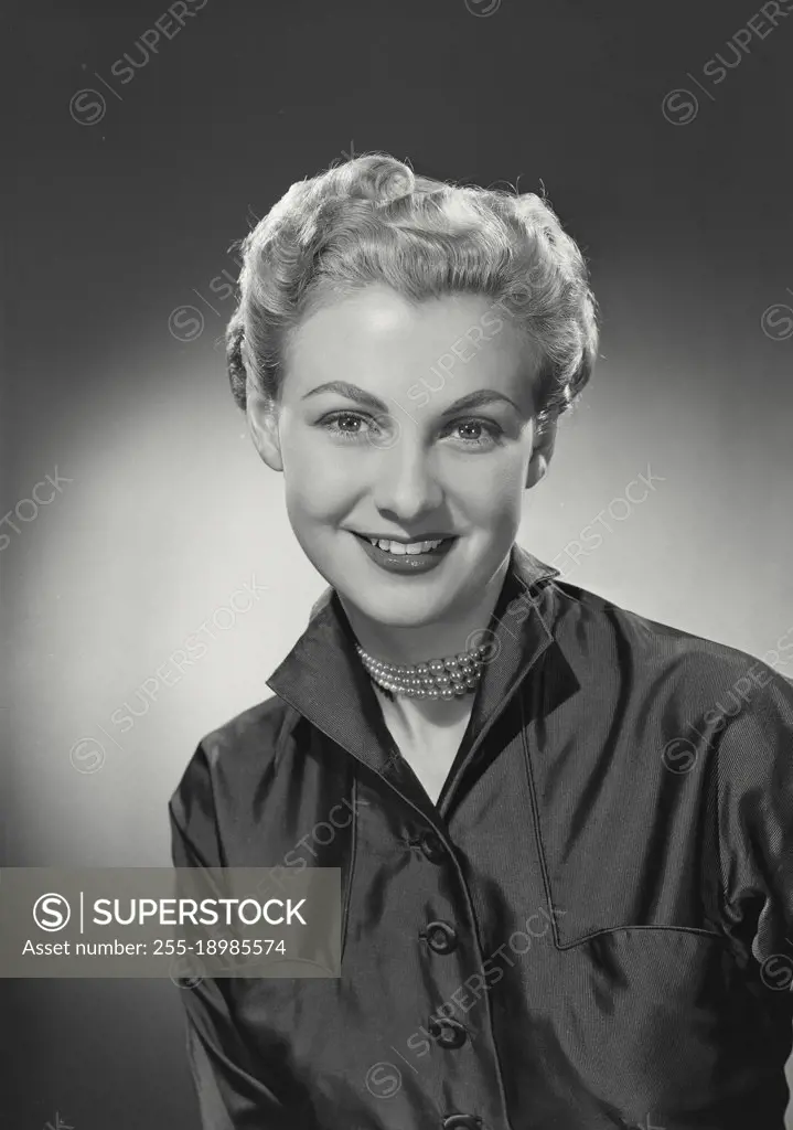 Vintage photograph. woman with short hair in button shirt smiling at camera