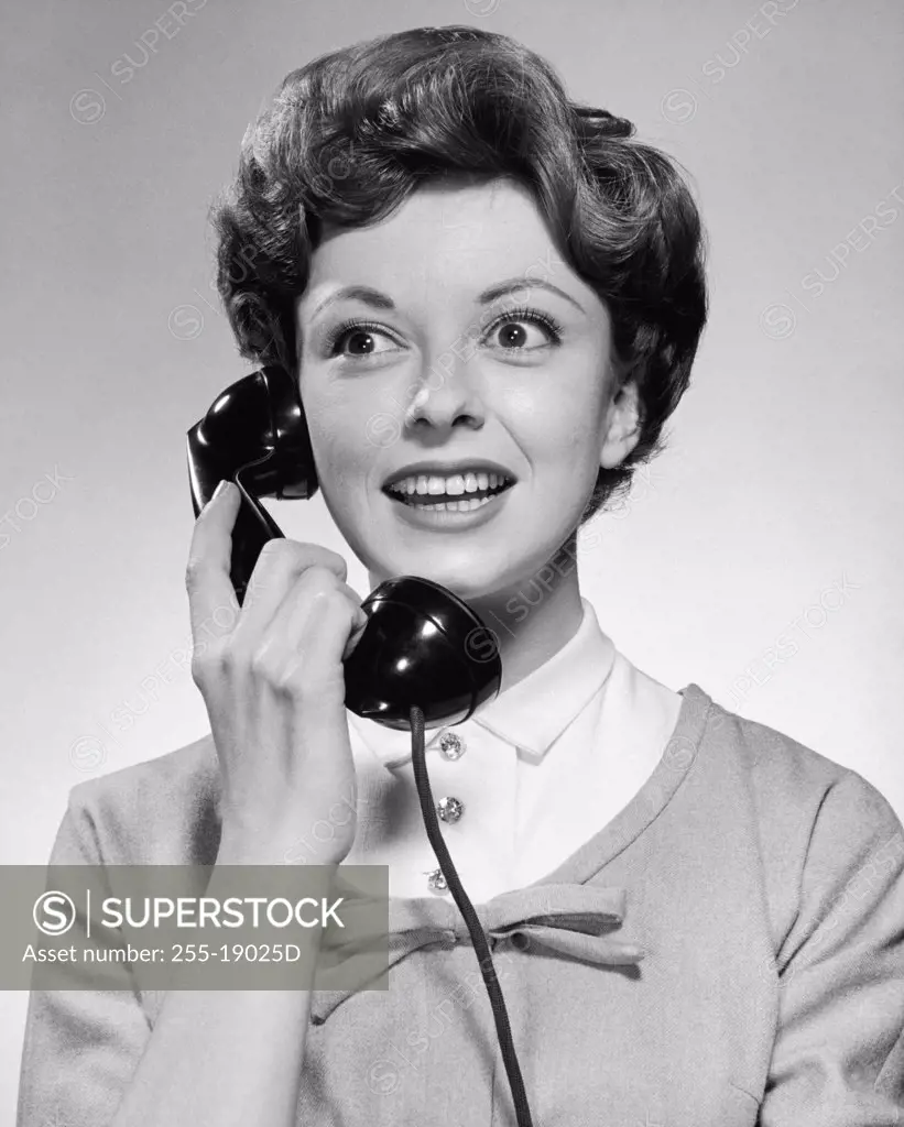 Close-up of a young woman talking on the telephone and smiling