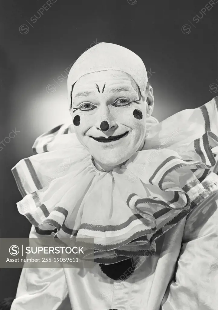 Vintage photograph. Portrait of clown in collar smiling.