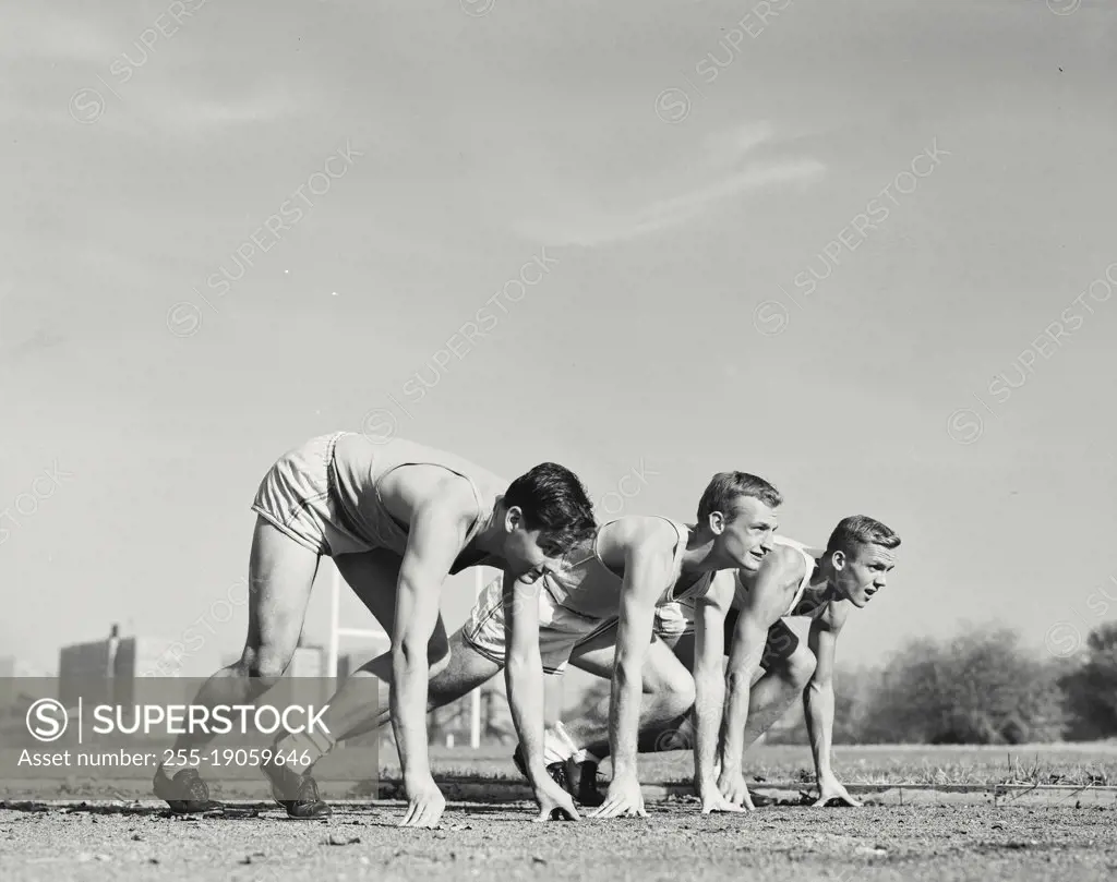 Vintage photograph. Runners on their mark about to sprint.