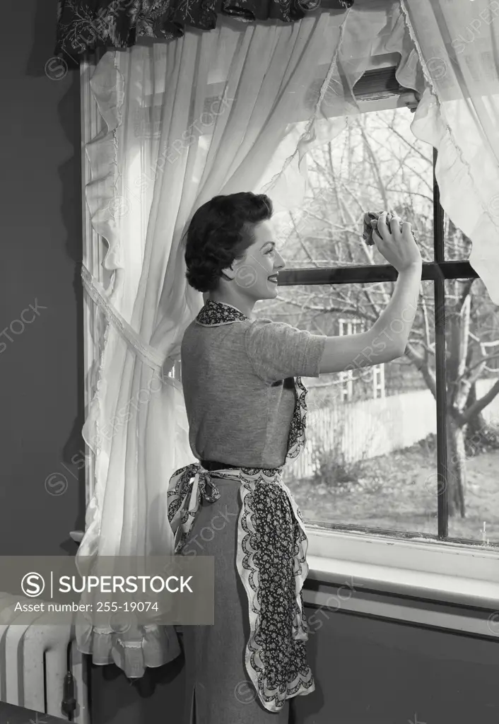 Vintage Photograph. Woman cleaning the windows. Frame 1