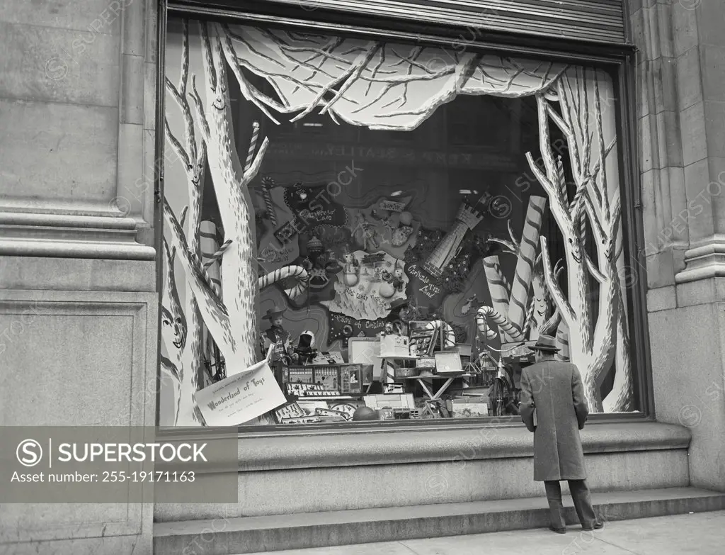 Vintage photograph. Man gazing through shop window.