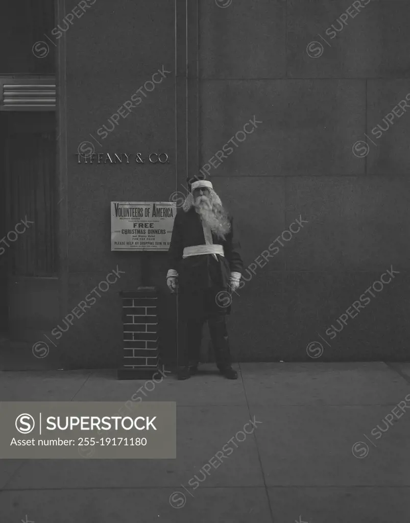 Vintage photograph. man in Santa suit in front of tiffany and co jewelry store