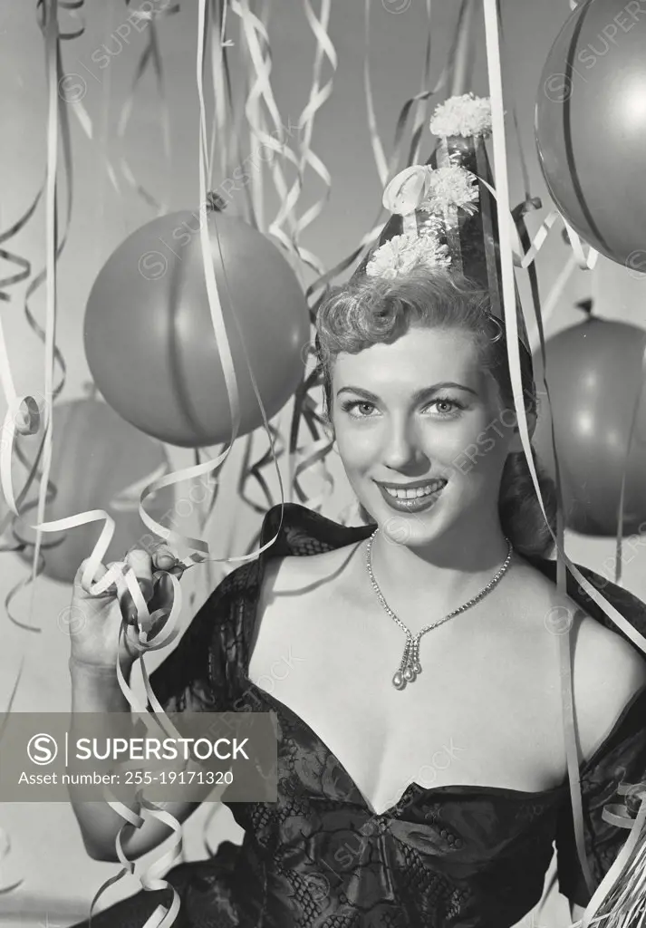Vintage photograph. Woman in party hat in party scene