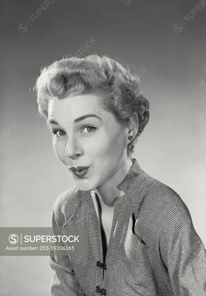Vintage photograph. Woman in button blouse smiling at camera