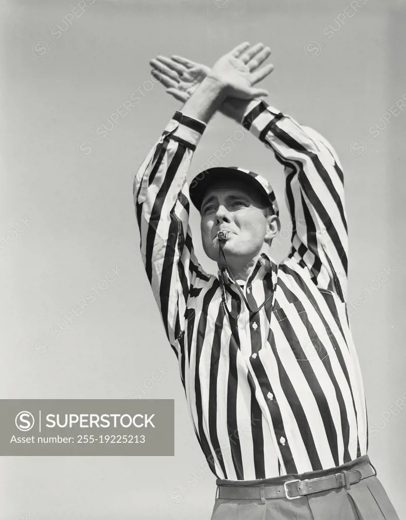 Vintage photograph. Football referee showing time out signal