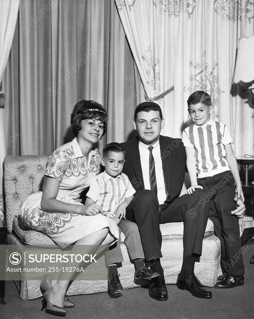 Portrait of a mid adult couple with their two sons, 1965